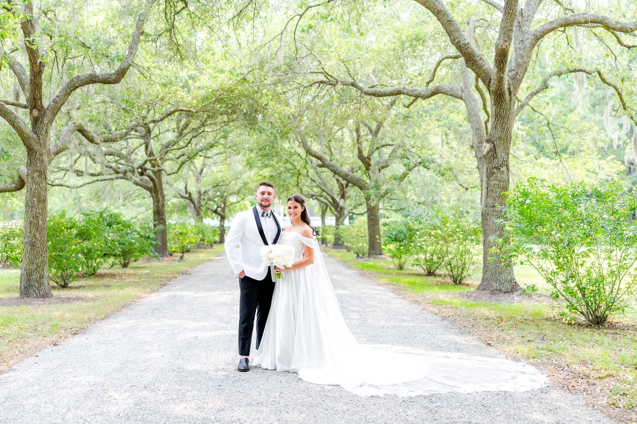Bride and Groom in Charleston under oak trees with spanish moss